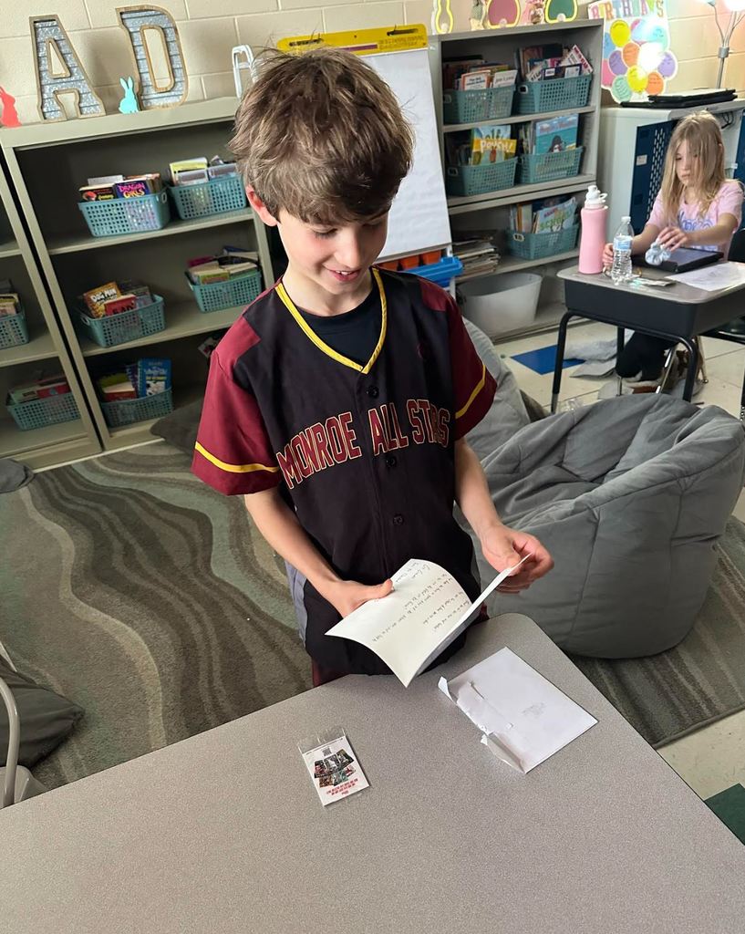 Ian opening a card and reading it with a smile