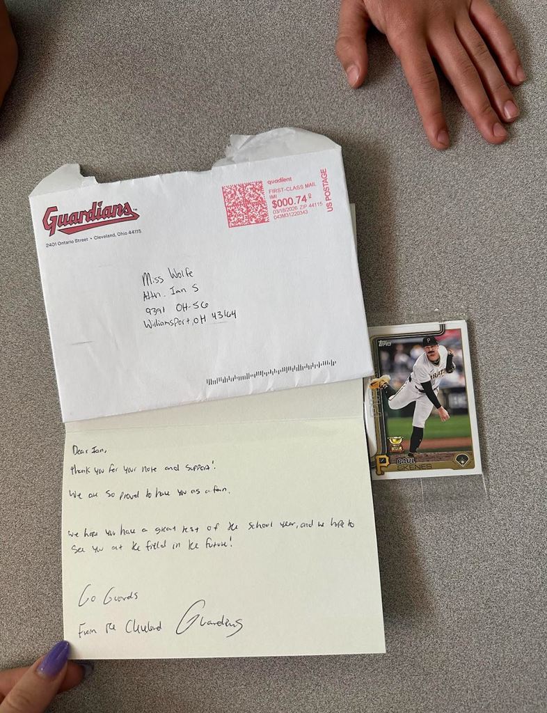 Letter from Cleveland Guardians with baseball car sitting on a desk
