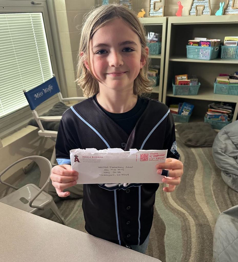 Jackson holding an envelope addressed to Westfall Elementary School