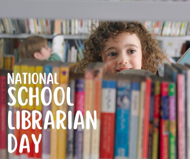 young girl looking over a shelf of books