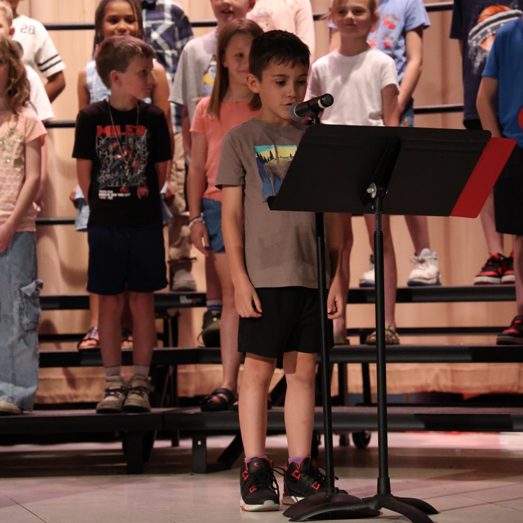 student speaking into a microphone