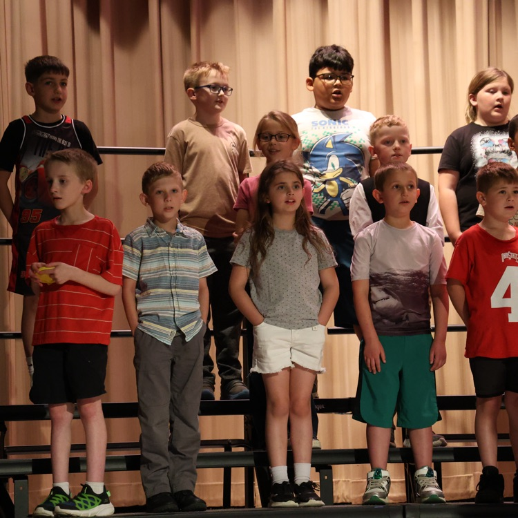 students standing on stage risers