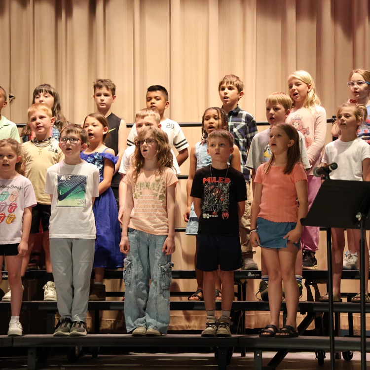 students standing on stage risers