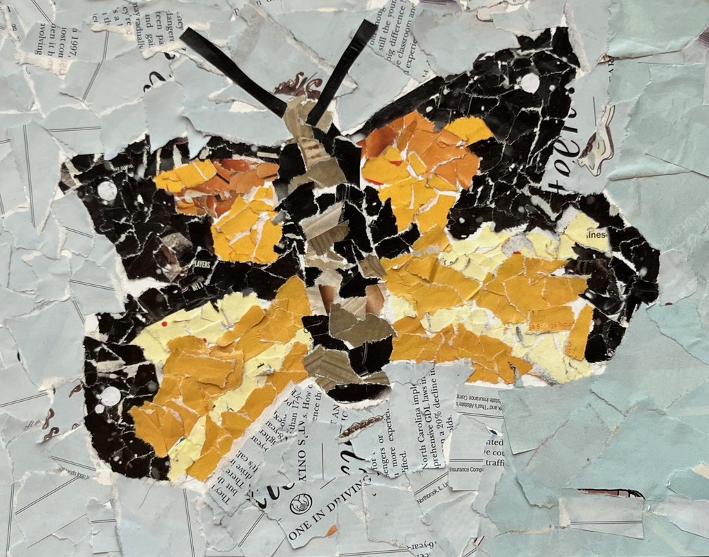 Colorful pieces of paper arranged to create a yellow/orange/black butterfly
