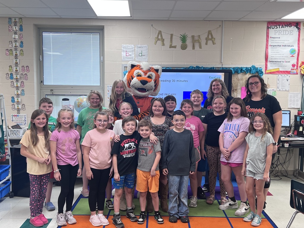 Cincinnati Bengals mascot posing with a class of male and female students with a teacher standing in the back