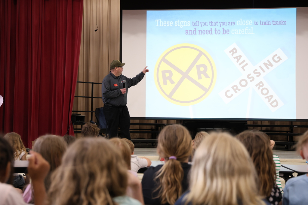 Rail Safety Inspector Joshua Elzey pointing to screen that shows railroad crossing signs