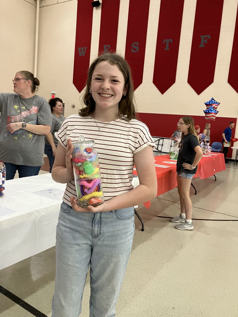 A student holding an estimation jar