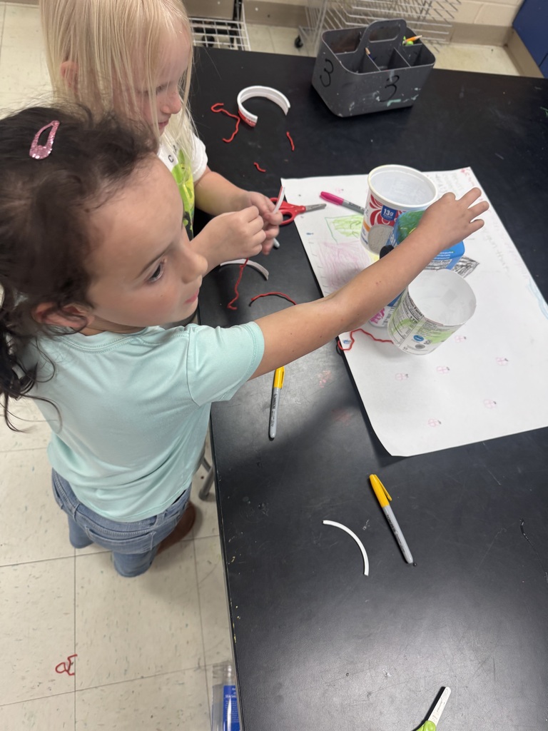 Student posing with environmental art piece