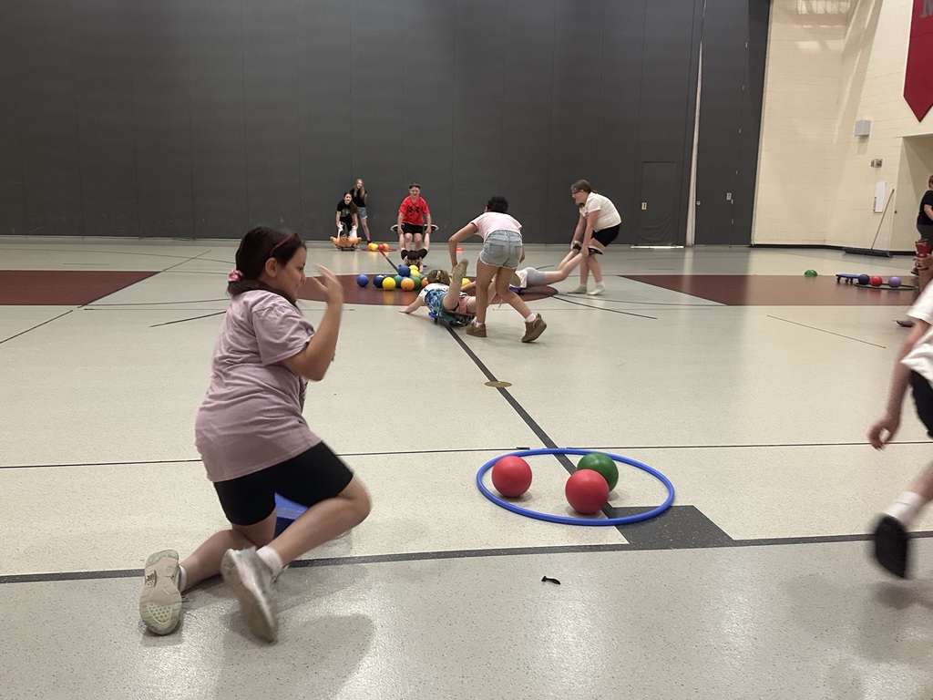 Students playing Hungry Hungry Hippos in gym class