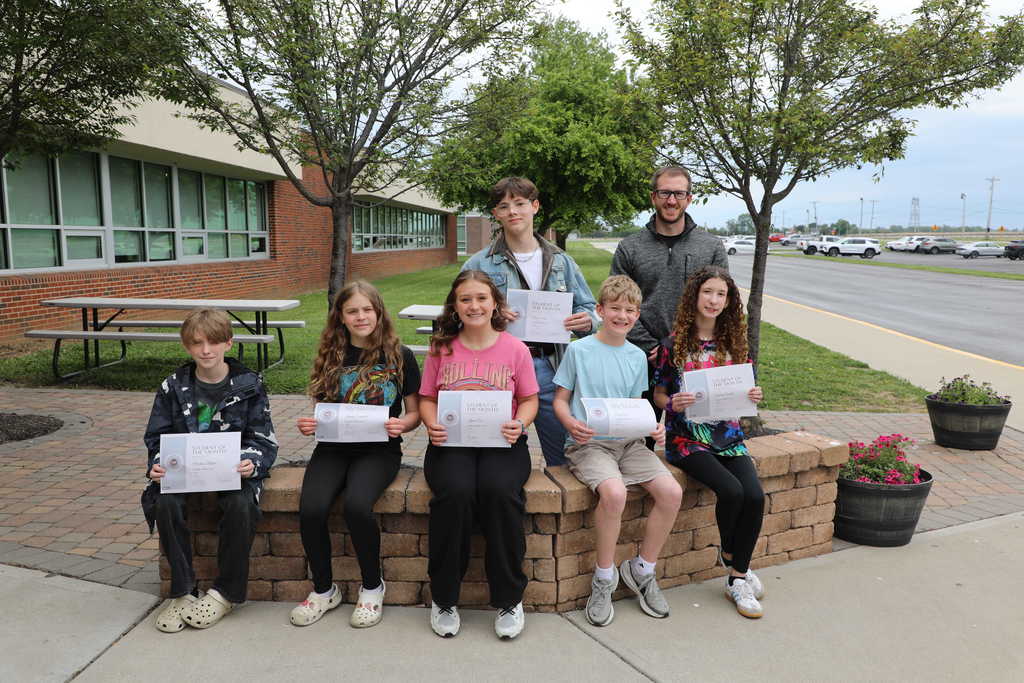 Students of the Month posing with certificates