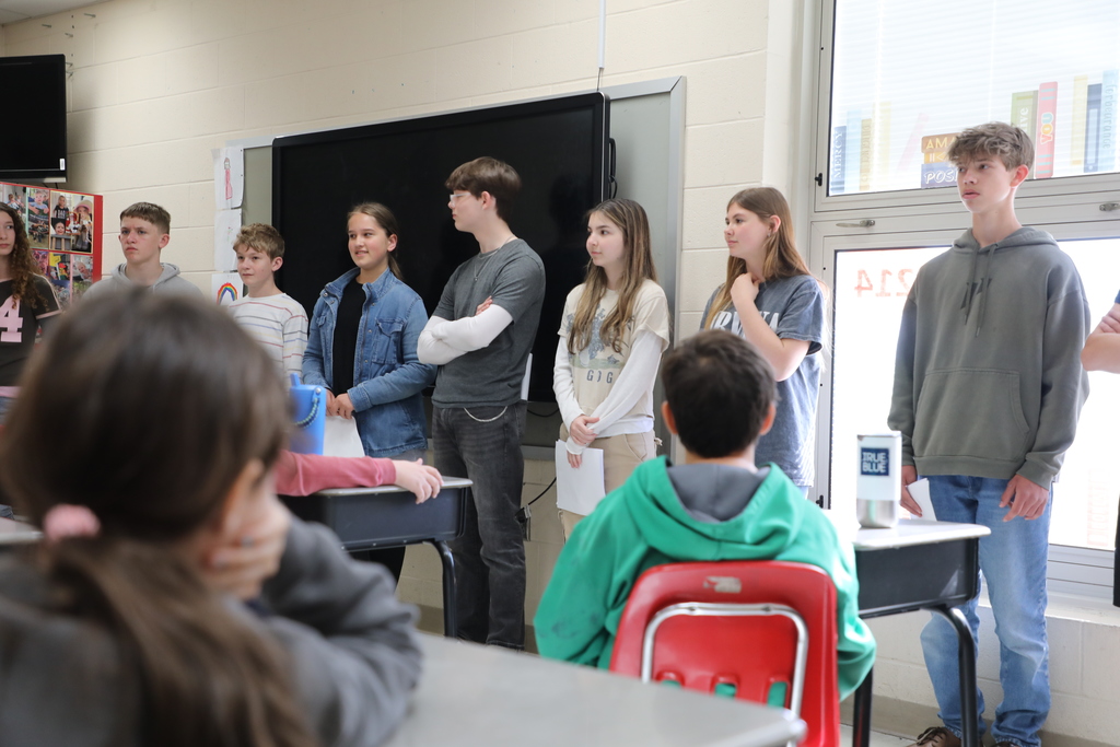 Students standing in front of class