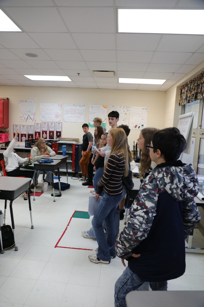 Students standing in front of class
