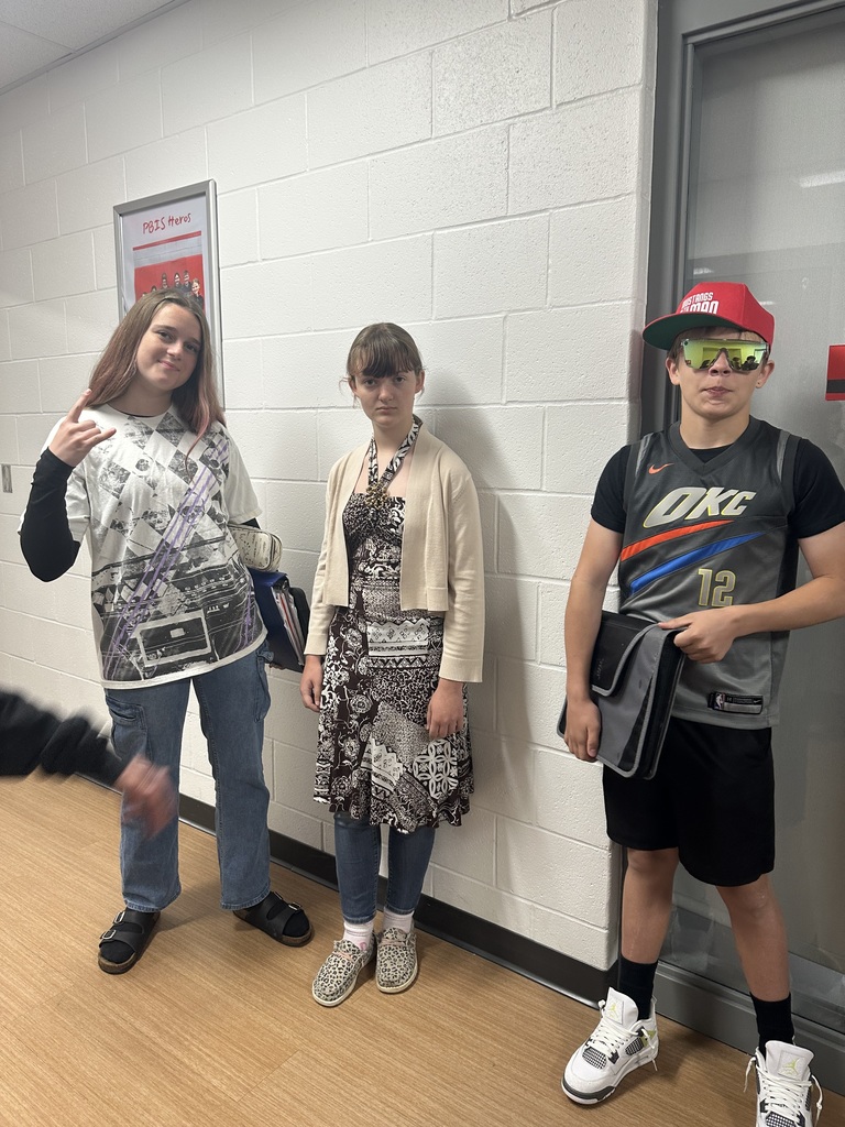 Three students standing next to each other