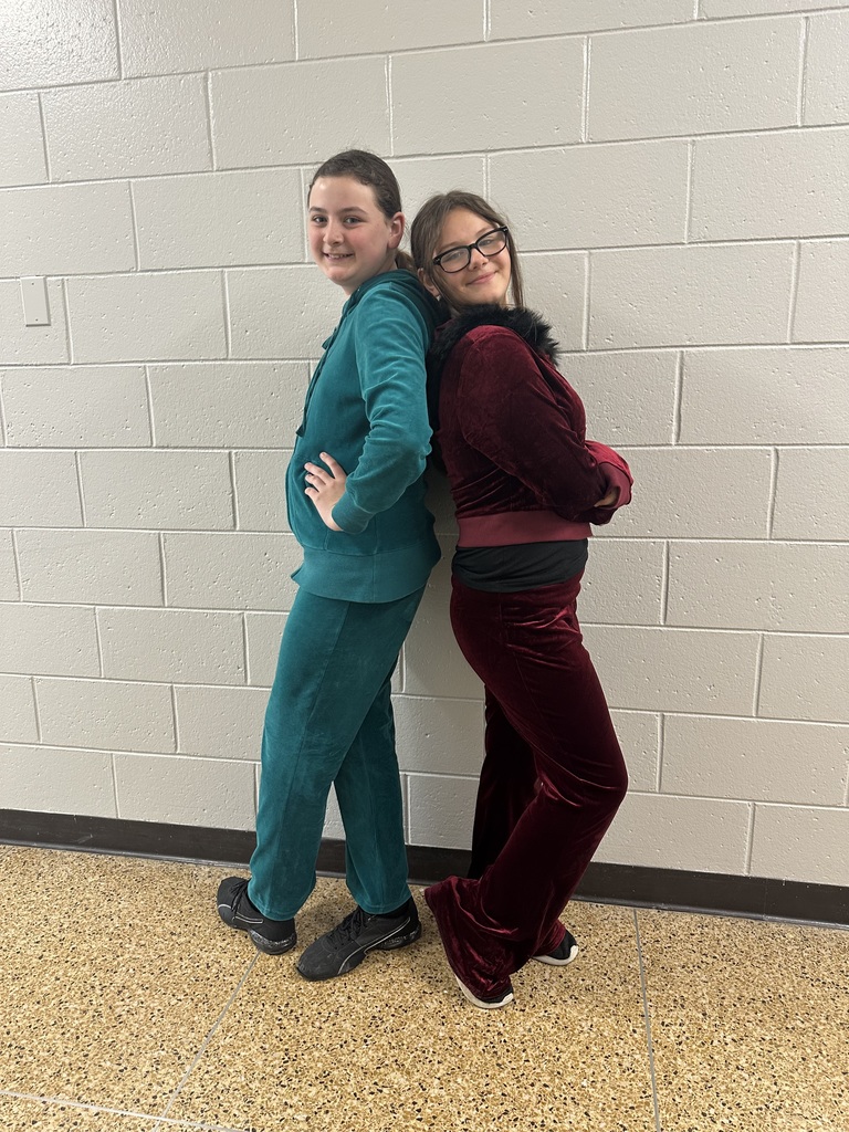 Two students standing back to back