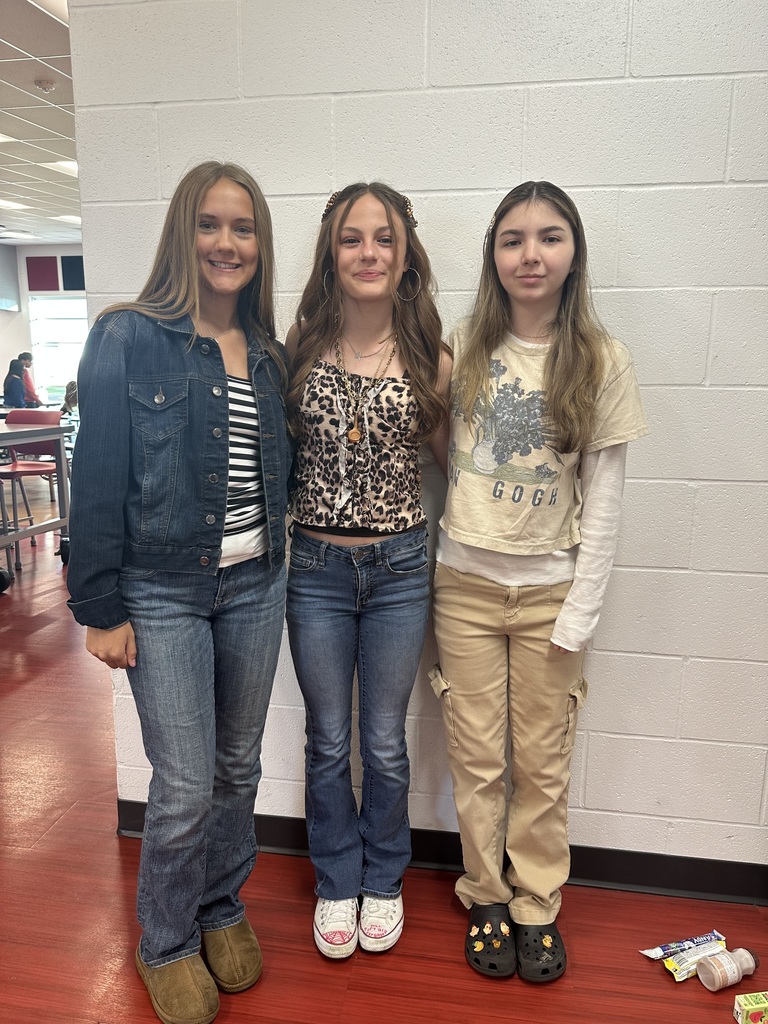 Three students standing next to each other