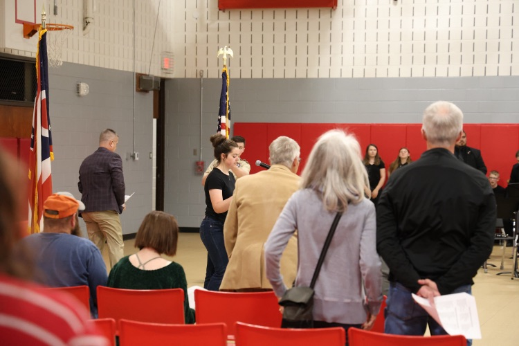 student at podium reciting pledge of allegiance