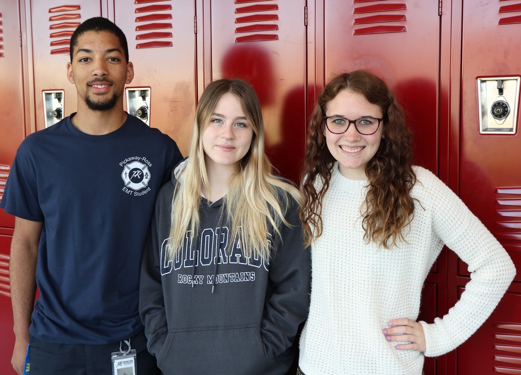 James Curtis, Arlee Goble, and Darby Eitel standing in front of red lockers