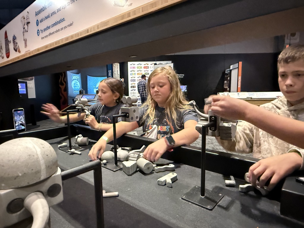 Students enjoying COSI exhibits