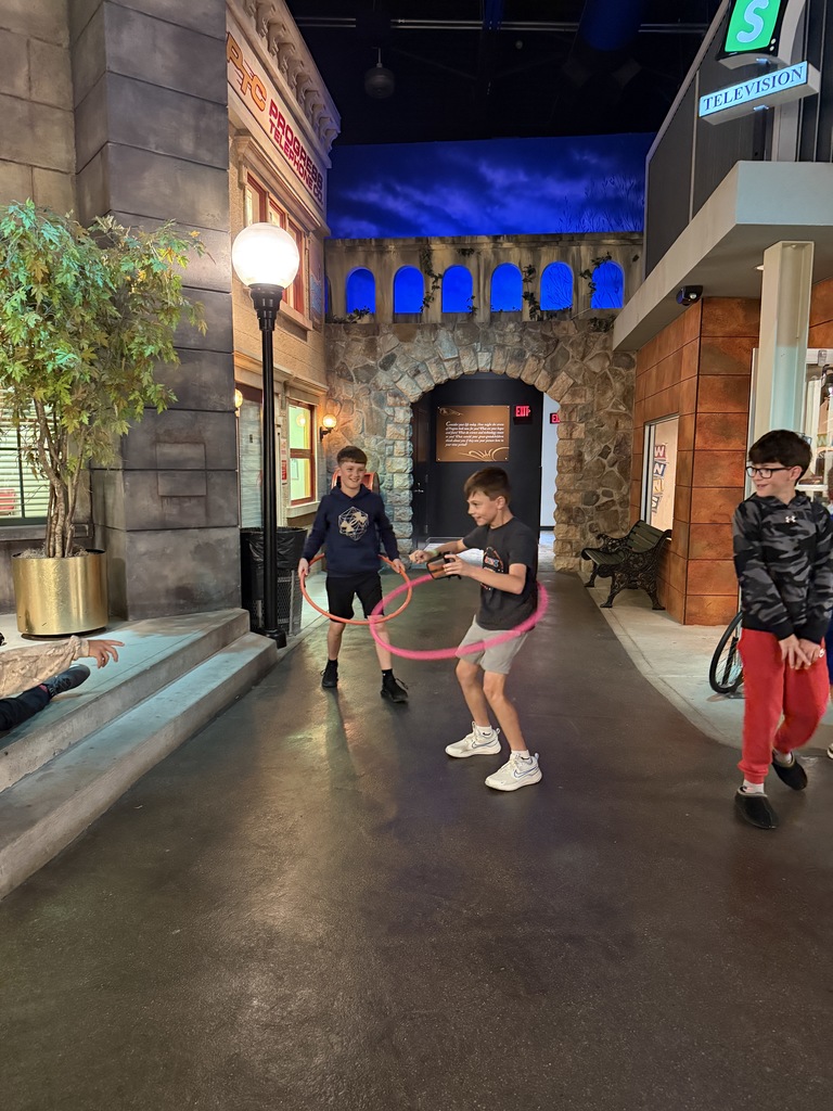 Students enjoying COSI exhibits
