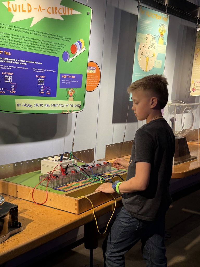 Student enjoying COSI exhibits