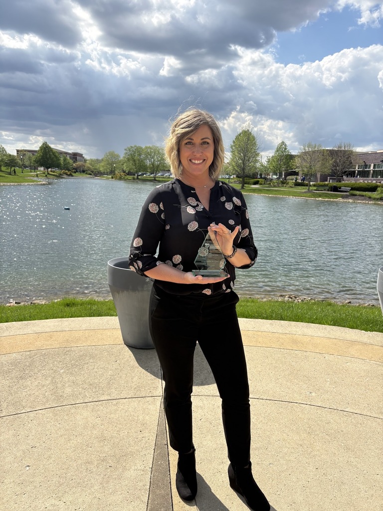 Emily Clark holding her Mark of Distinction Award