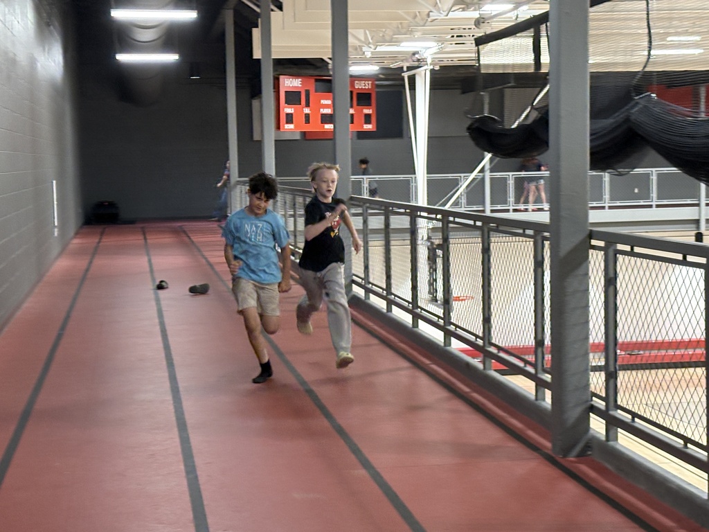 Students running on the mezzanine track