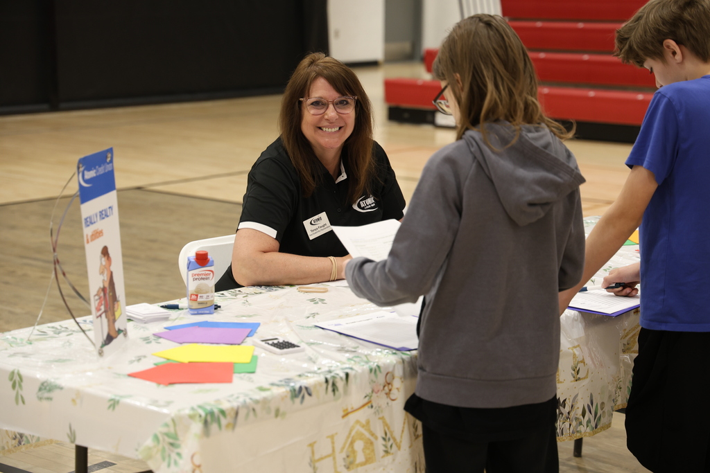 Students participating in Mad City Money simulation in the MAC gymnasium
