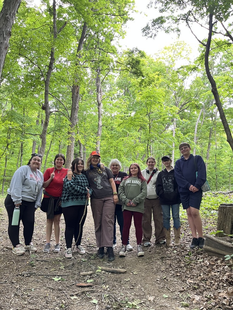 Teachers and students posing in the woods