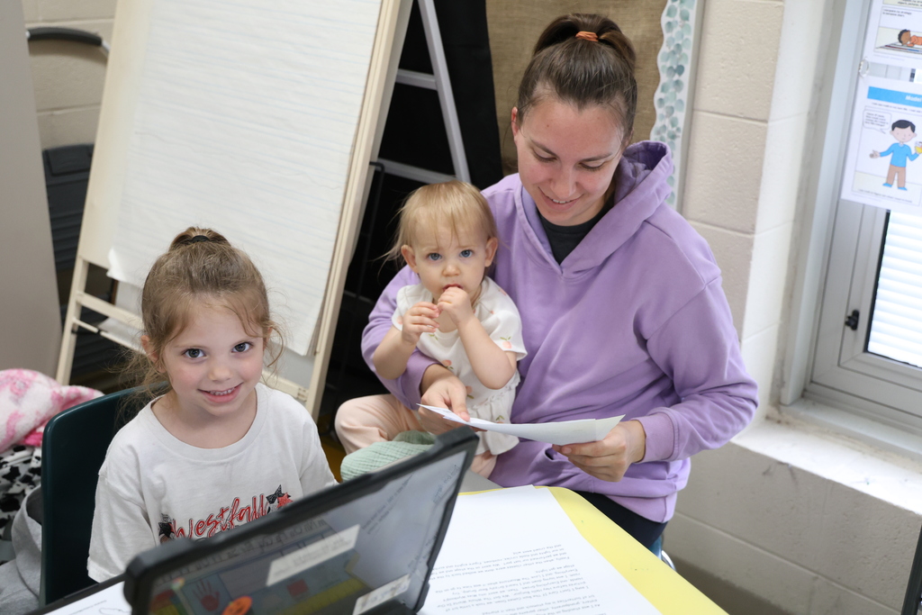 Students reading to their family members and guests