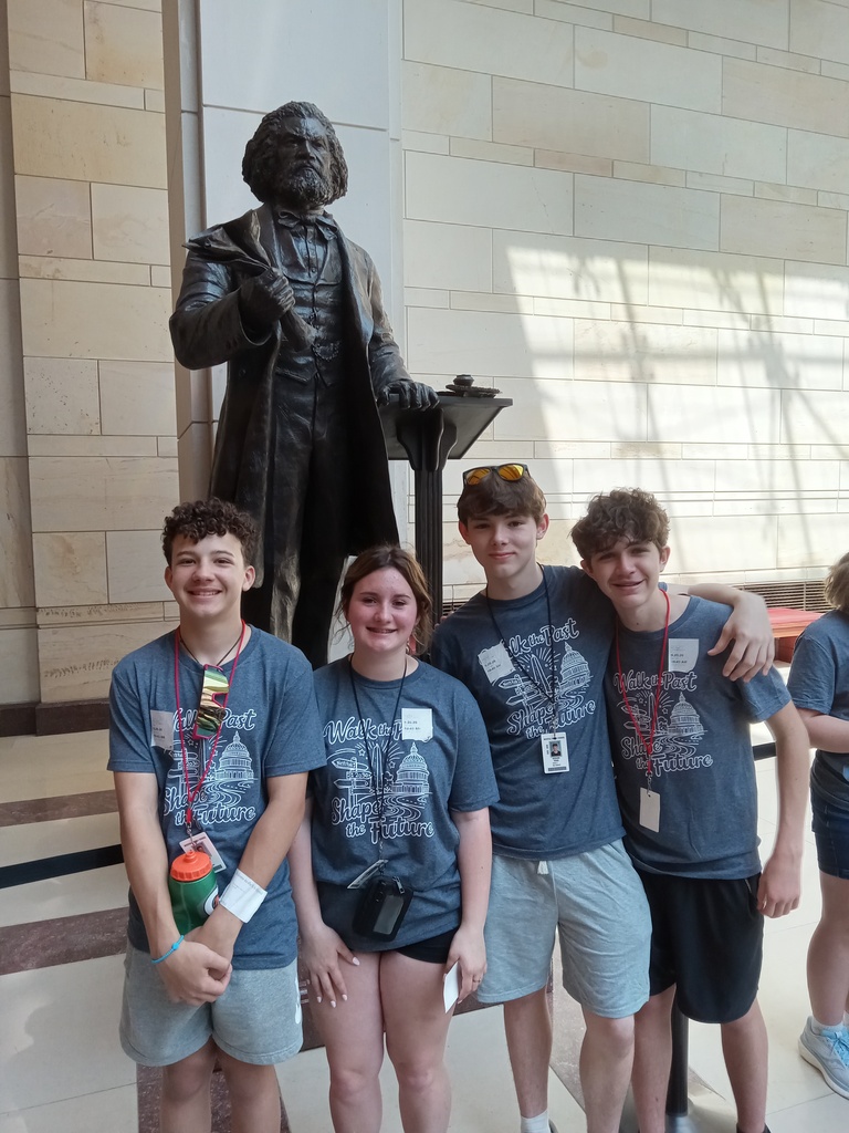 Students standing in front of statue