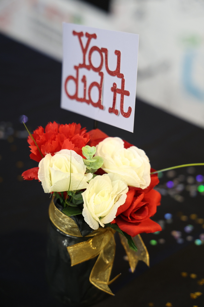 Flowers with a sign that reads You did it