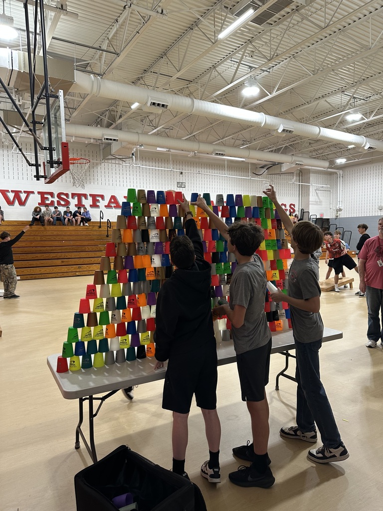 Kids stacking cups into a pyramid