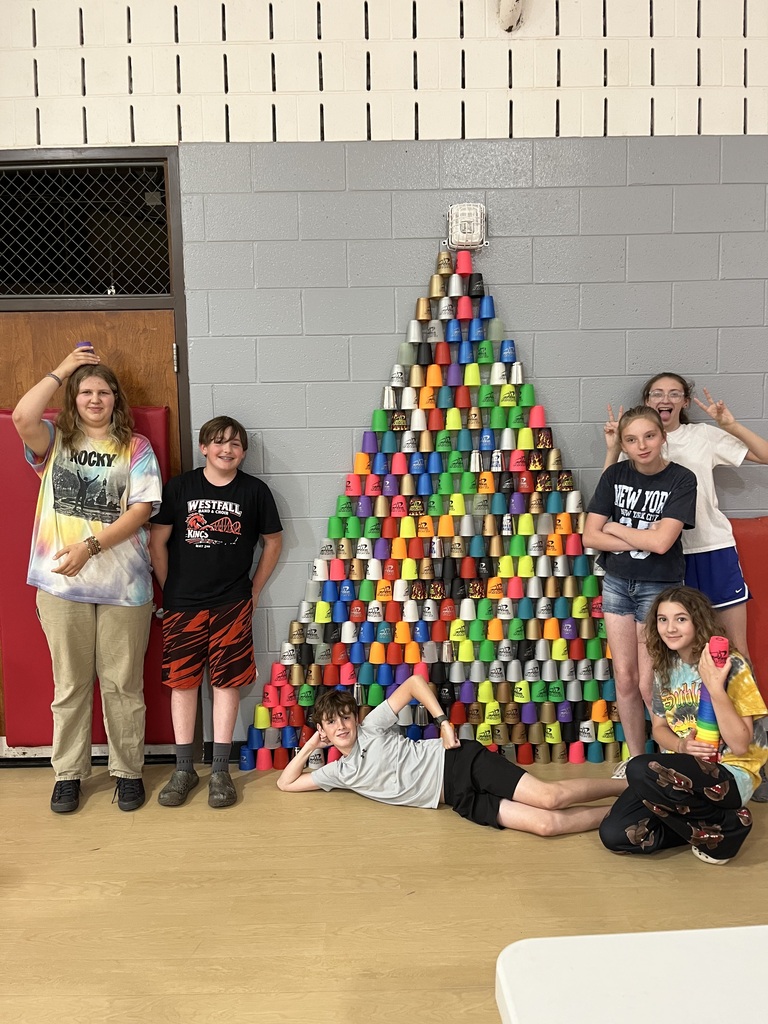 Kids stacking cups into a pyramid