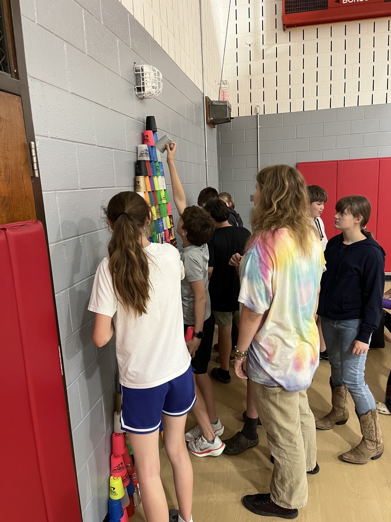 Kids stacking cups into a pyramid