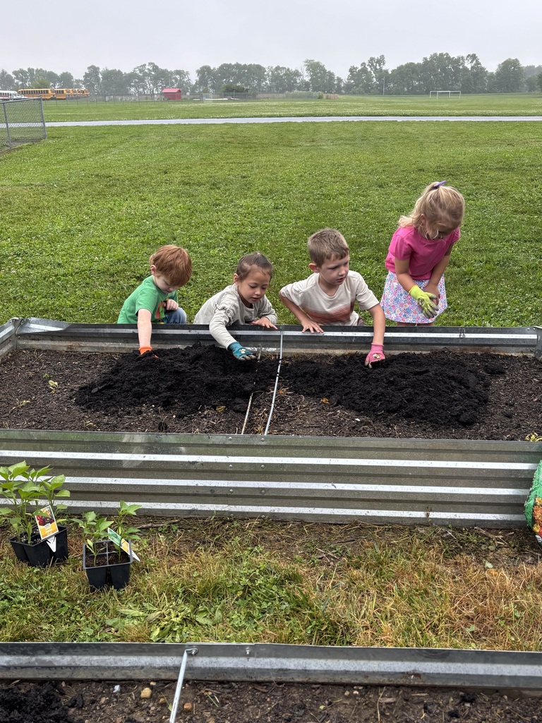 Students working in a raised garden