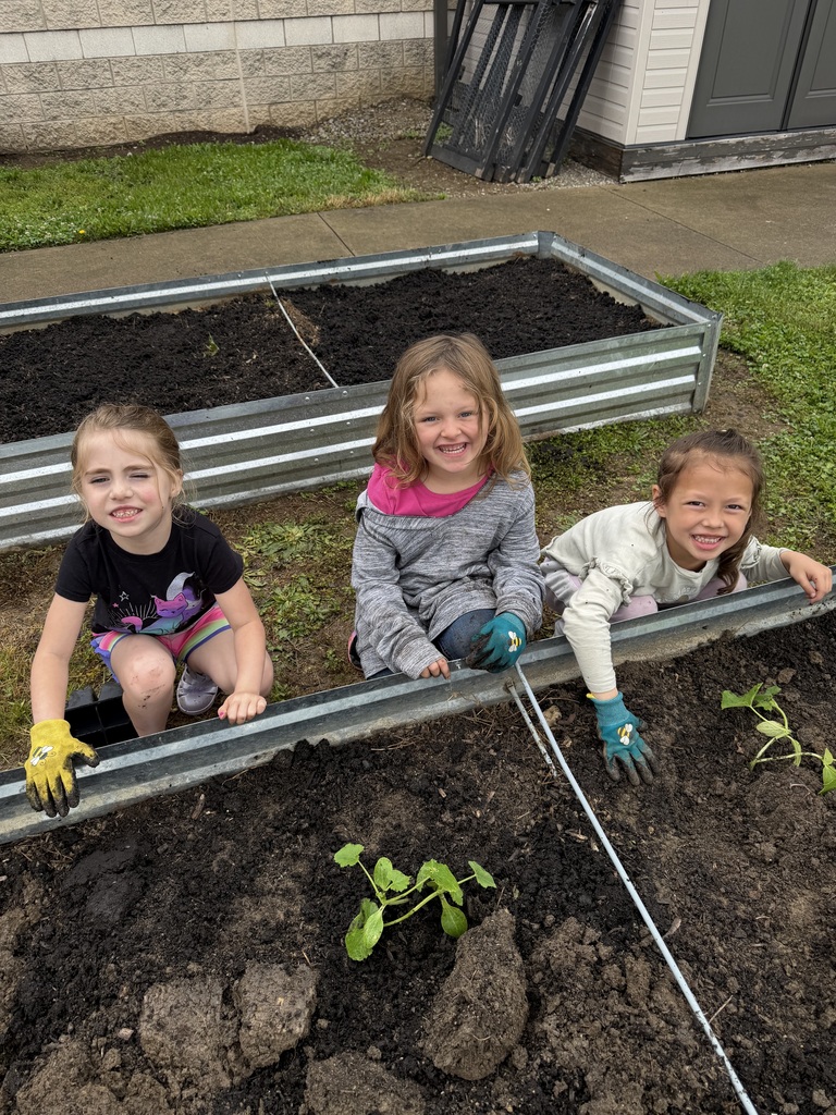 Students working in a raised garden