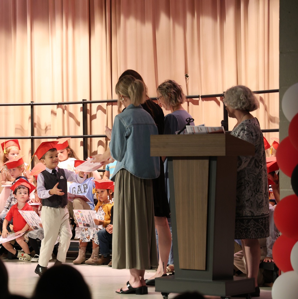 Preschool Graduate receiving his diploma