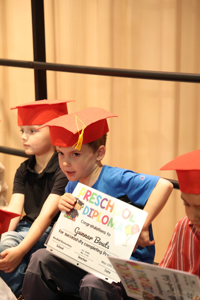 Preschool Graduate holding his diploma
