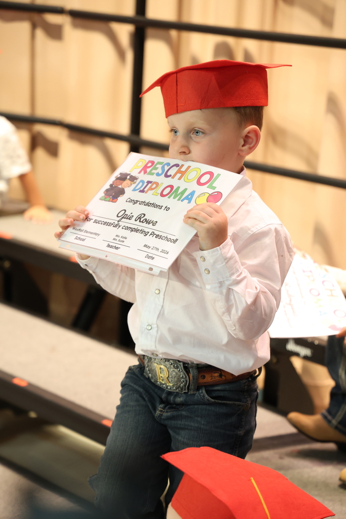 Preschool Graduate holding his diploma
