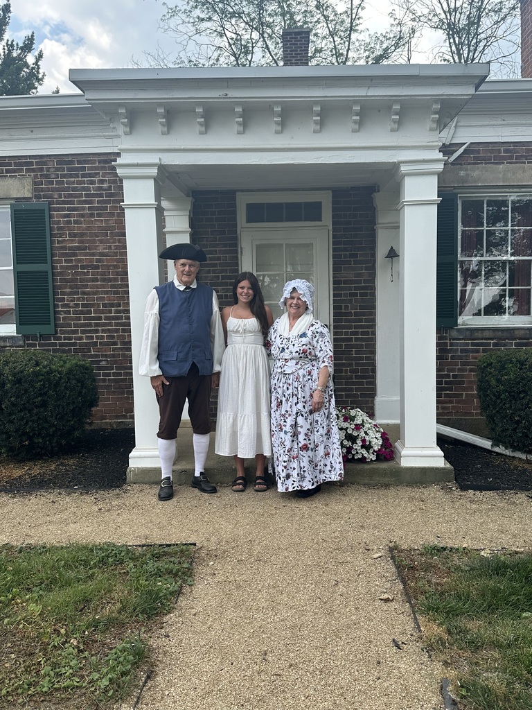Lu Coon posing with a man and woman dressed in colonial outfits