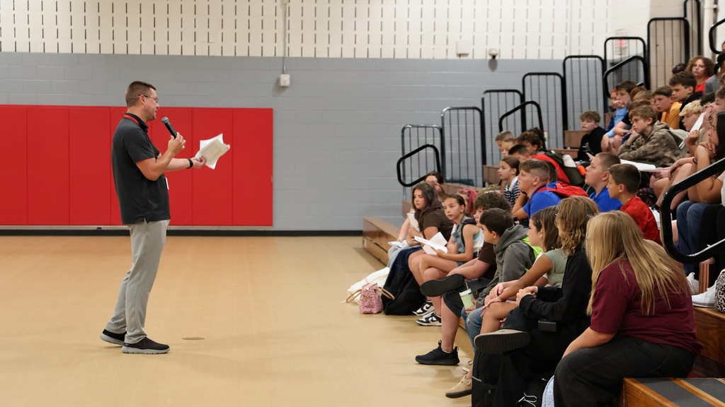 Dean of Students speaking to a group of students