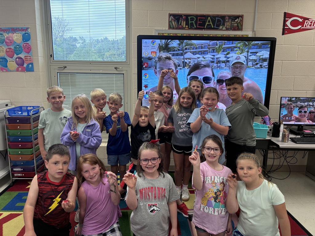 Students holding up gummy worms