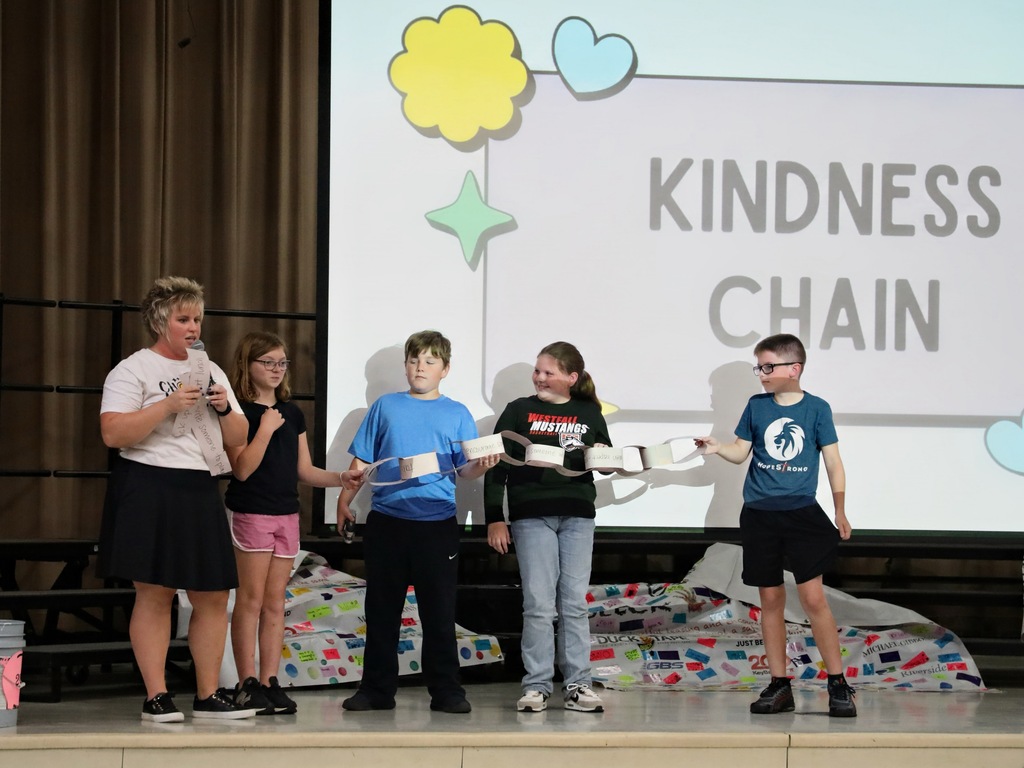 Students holding completed paper chain