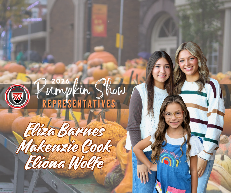 2026 Pumpkin Show representatives Eliza Barnes, Makenzie Cook, and Eliona Wolfe standing in front of a table full of pumpkins