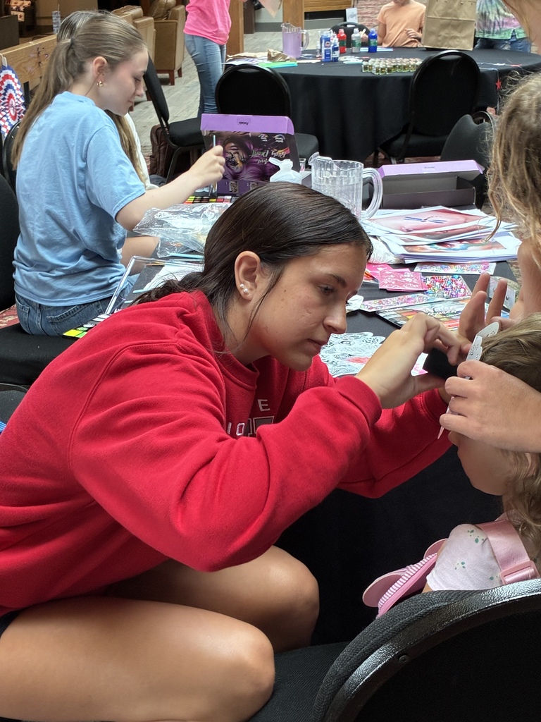 Student facepainting a child's face