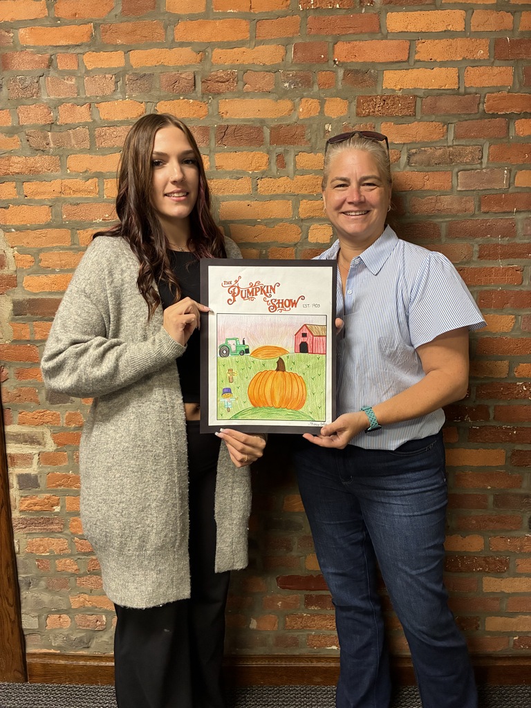 Mercy Artis with representative from Health Care Logistics holding Pumpkin Show artwork
