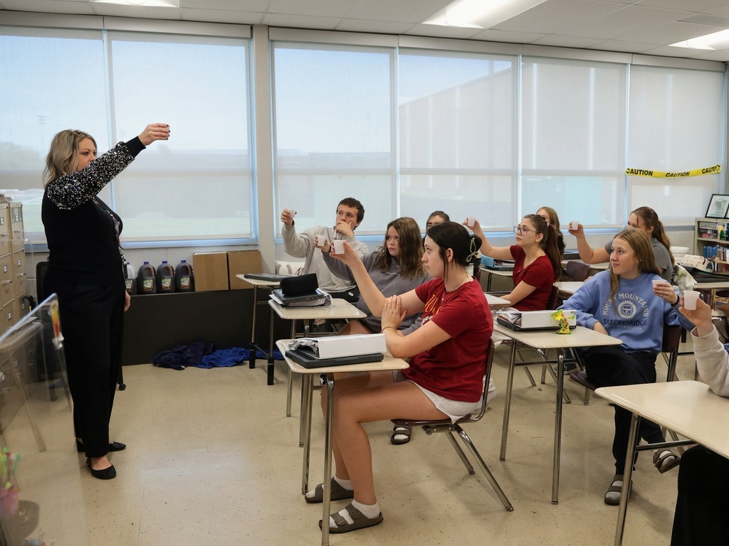 Students holding up their sweet tea cups to toast Dolly