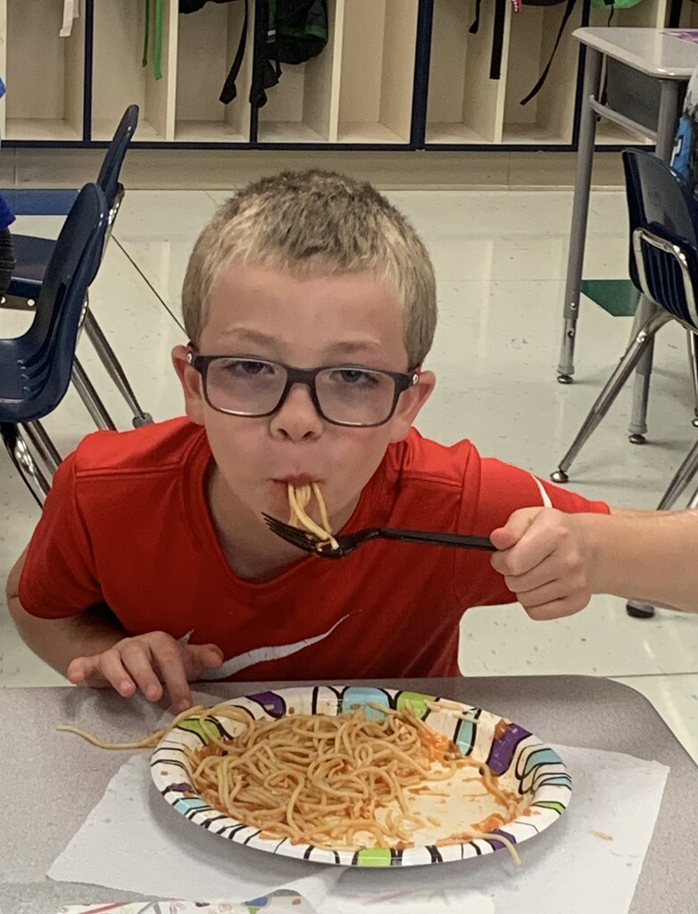 Student eating spaghetti