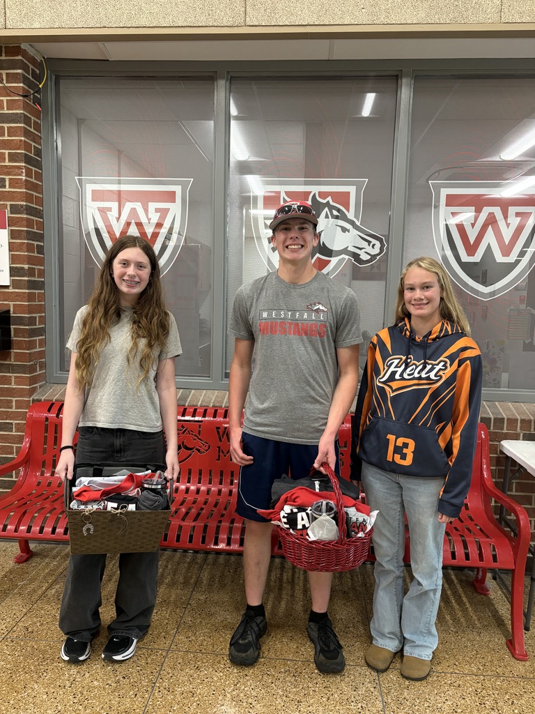 Students holding raffle baskets full of Westfall Mustang gear