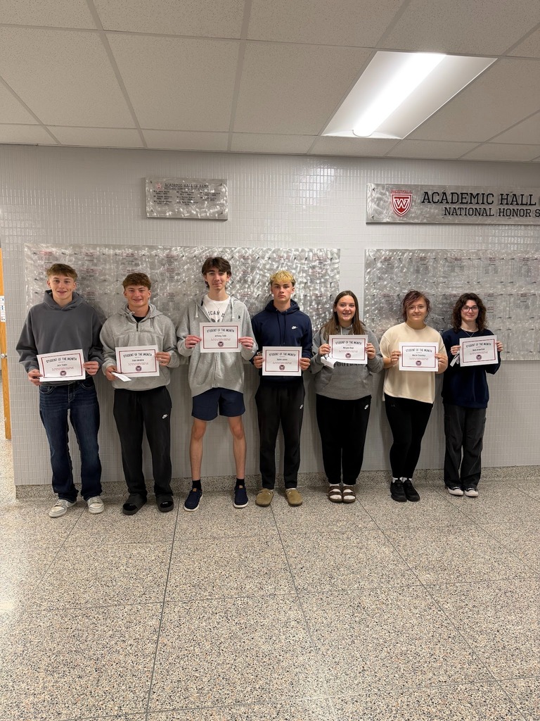 Students of the Month holding certificates